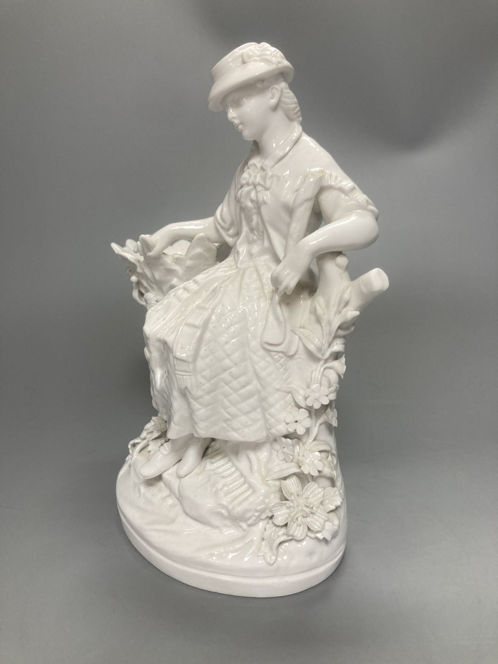 A pair of John Bevington bone china figures, gardener and female companion, 21.5cm
